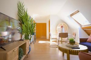 a living room with a couch and a table at Edificio Leganitos in Madrid