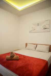 a bedroom with a bed with a towel on it at Limasan514 in Timuran