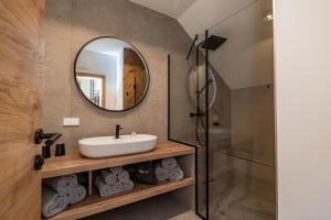 a bathroom with a sink and a mirror at Landhaus Jenul in Tröpolach