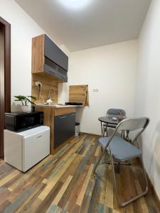 a kitchen with a table and a chair in a room at Navial in Gabrovo