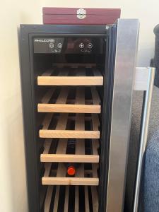 a refrigerator filled with wine bottles at Nový apartmán v klidu Jizerek in Smržovka