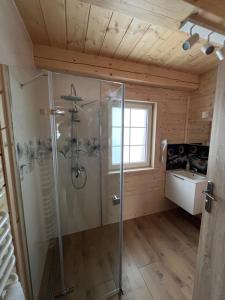 a bathroom with a shower and a sink at Domki - Zajazd Zieleńska Polana in Wisła