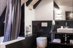 a bathroom with a toilet and a sink at Tralala Hotel Montreux in Montreux +134 photos