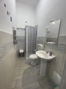 a white bathroom with a toilet and a sink at B&B La Cumana in Naples +20 photos