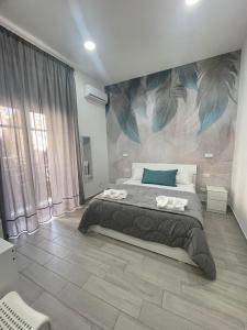 a bedroom with a large bed with a mural on the wall at B&B La Cumana in Naples