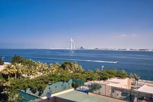 a view of the ocean with a boat in the water at Rixos The Palm Hotel & Suites - Ultra All Inclusive in Dubai