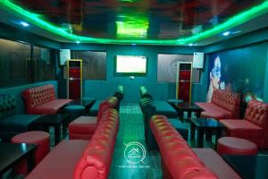a game room with red chairs and a table and a scoreboard at THE HOUSE ABUJA in Abuja