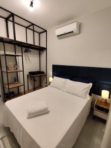 Postel nebo postele na pokoji v ubytování Loft 61 - No coração de Curvelo