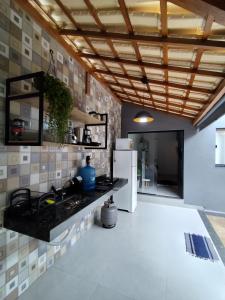 a kitchen with a sink and a refrigerator at Loft 61 - No coração de Curvelo in Curvelo