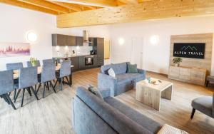 a living room with a couch and a table at Alpenstyle Resort Fieberbrunn by AlpenTravel in Fieberbrunn