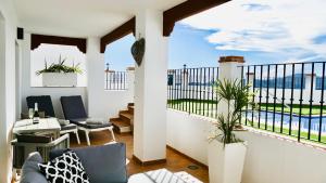 a living room with a balcony with a view at Casita Frigiliana - stunning new apartment with views with private parking space in Frigiliana