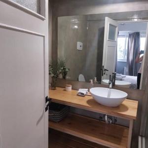 a bathroom with a sink and a large mirror at The cutest Apartment in the best area of Belgrano in Buenos Aires