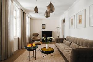 a living room with a couch and a table at The Drisco Hotel Tel Aviv - Relais & Châteaux in Tel Aviv