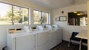 a row of washing machines in a room with windows at Motel 6-Chico, CA in Chico