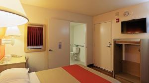 a hotel room with a bed and a bathroom at Motel 6-Chico, CA in Chico