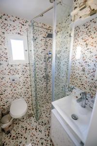 ein Bad mit einer Dusche, einem WC und einem Waschbecken in der Unterkunft dreamy loft at 10th floor in Thessaloniki