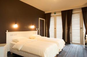 Postel nebo postele na pokoji v ubytování Thermae Grimbergen Hotel
