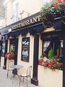 a restaurant with a table and chairs on a street at The Western Hotel in Claremorris