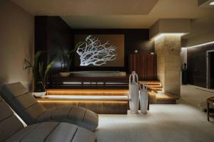 a living room with a couch and a tree on the wall at Villa Lena Puglia in Oria