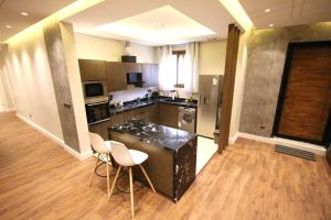 a kitchen with a counter and chairs in a room at شقة ارضية واسعة Spacious Ground Floor Apartment in Riyadh +17 photos
