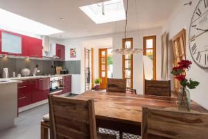 a kitchen with a wooden table and a dining room at Top City Apartment Uniklinik in Freiburg im Breisgau