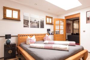 a bedroom with a bed with pillows on it at Top City Apartment Uniklinik in Freiburg im Breisgau