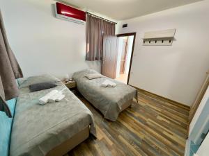 a bedroom with two beds and a window at Navial in Gabrovo