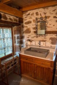 a bathroom with a sink and a mirror at gîte "le seccadou" Ecuries de Saint Maurice in Lacapelle-Marival