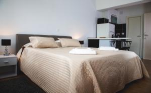 a bedroom with a bed with two towels on it at Apartment Victoria II in Dubrovnik