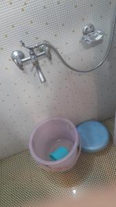 a water bowl in a bathroom with a faucet at Goroomgo Comfort Hostel Charbagh Lucknow Near Railway Station in Lucknow