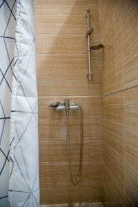 a shower with a hose in a bathroom at Apartment Victoria II in Dubrovnik