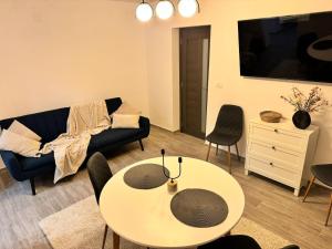 a living room with a couch and a table at Apartament Mahmudia - Casa Anastasia Murighiol in Mahmudia