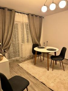 a dining room with a table and chairs at Apartament Mahmudia - Casa Anastasia Murighiol in Mahmudia