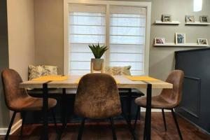 a dining room table with chairs and a plant on it at Large Cozy House Near NexusPark Air Hockey in Columbus