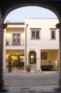 an archway in front of a white building at Al-Tair in San Vito lo Capo
