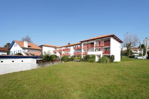 a building with a grass field in front of it at Bidasoabanks in Hendaye