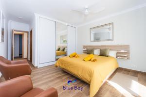 a bedroom with a bed with yellow sheets and a chair at Atmosphere Luxury Townhouse with Private Pool in La Herradura +84 photos