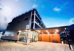 a black building with a lot of windows at Peema Villa ภีมะ วิลล่า in U Thong