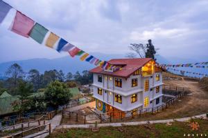 a house with a prayer flag hanging from it at Zostel Rinchenpong (Pelling) in Rinchingpong