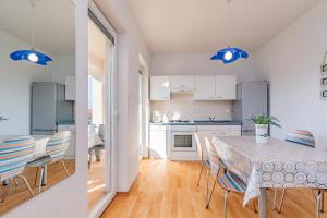 a kitchen and dining room with a table and chairs at Apartments Mirjana * central location and close to beach in Punat