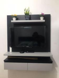 a flat screen tv sitting on a white shelf at Victoria Room in Dukuh