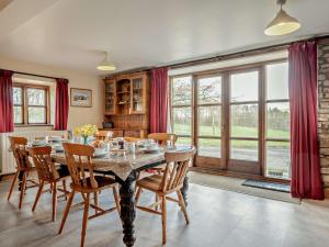 a dining room with a table and chairs at 4 Bed in Hay on Wye 90375 in Builth Wells