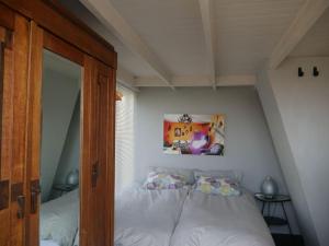 a bedroom with a bed and a picture on the wall at Lovely house on the water near Amsterdam in 's-Graveland
