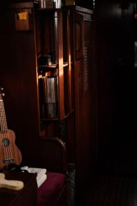 a guitar sitting on a chair in a room at The Captains Locker - 30ft Yacht in San Miguel de Abona
