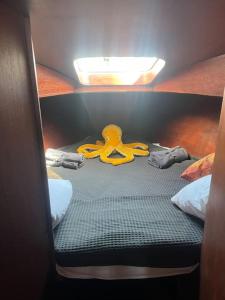 a small bed with a pair of scissors on it at The Captains Locker - 30ft Yacht in San Miguel de Abona