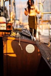 a woman standing on the side of a boat at The Captains Locker - 30ft Yacht in San Miguel de Abona