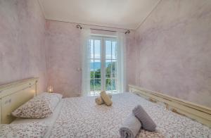 a bedroom with a bed with two towels on it at Villa Linna with seaview in Pinezici +26 photos