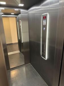 a metal elevator in a room with a hallway at Studio Apartment mit Stellplatz in Bielefeld