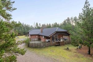 a house with a gambrel roof on a yard at Large Cottage In Peaceful, Beautiful Nature in Mølby