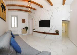 a living room with a couch and a tv on a wall at extra luxury apartment salerno center in Salerno